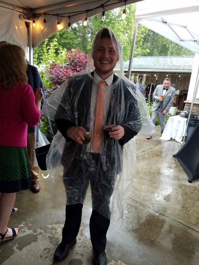 Guest In A Poncho Rainy Wedding In The Pacific Northwest At The Lookout Lodge In Snohomish