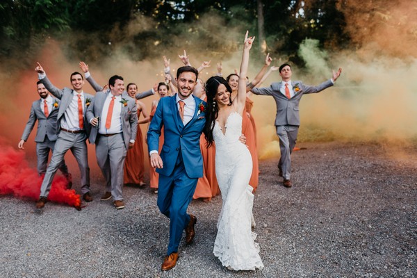 snohomish wedding colorful smoke bombs bride groom blue suit wedding party bridesmaids and groomsmen at the lookout lodge Photography by Anna Szczekutowicz
